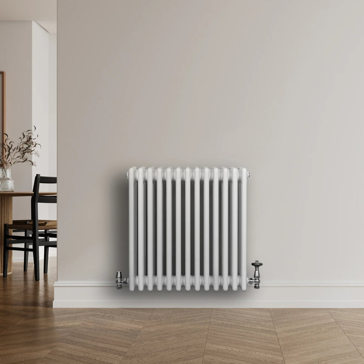 Traditional white 4 column radiator, 600 x 605mm, featuring a sleek design with smooth, glossy finish and chrome valves against a neutral wall