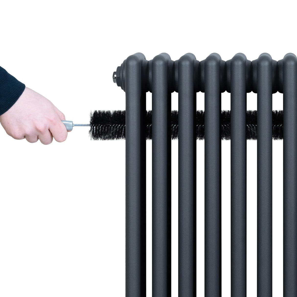 Traditional anthracite grey 4 column radiator being cleaned with a brush, showcasing its sleek design and smooth finish