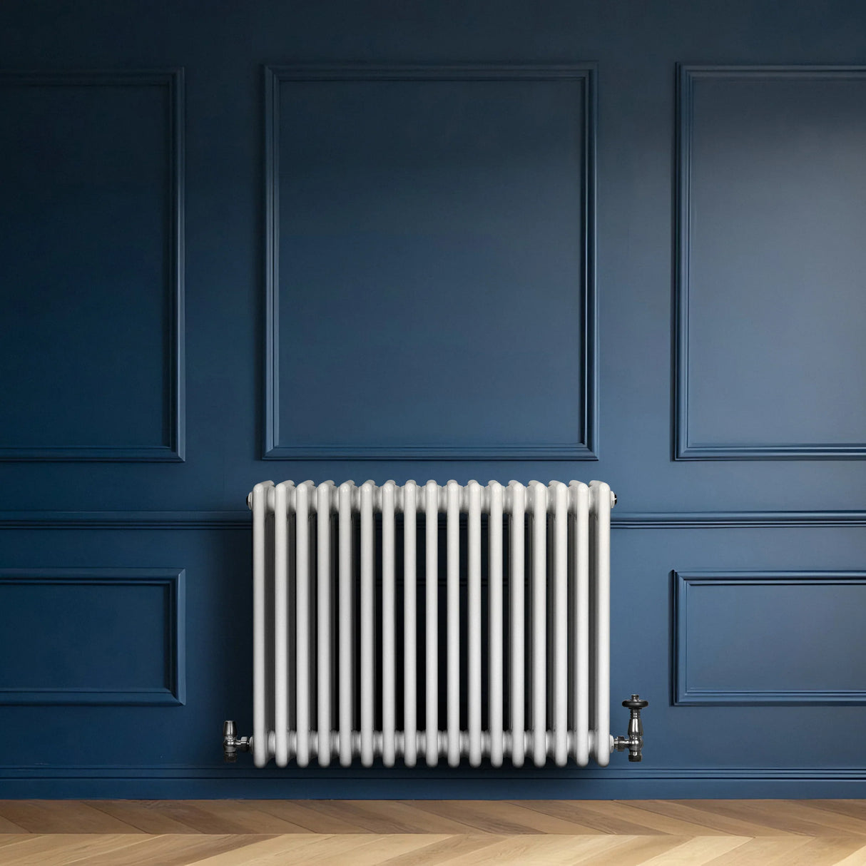 Traditional 4 column radiator in white, 600 x 785mm, featuring a sleek design against a deep blue wall and wooden floor