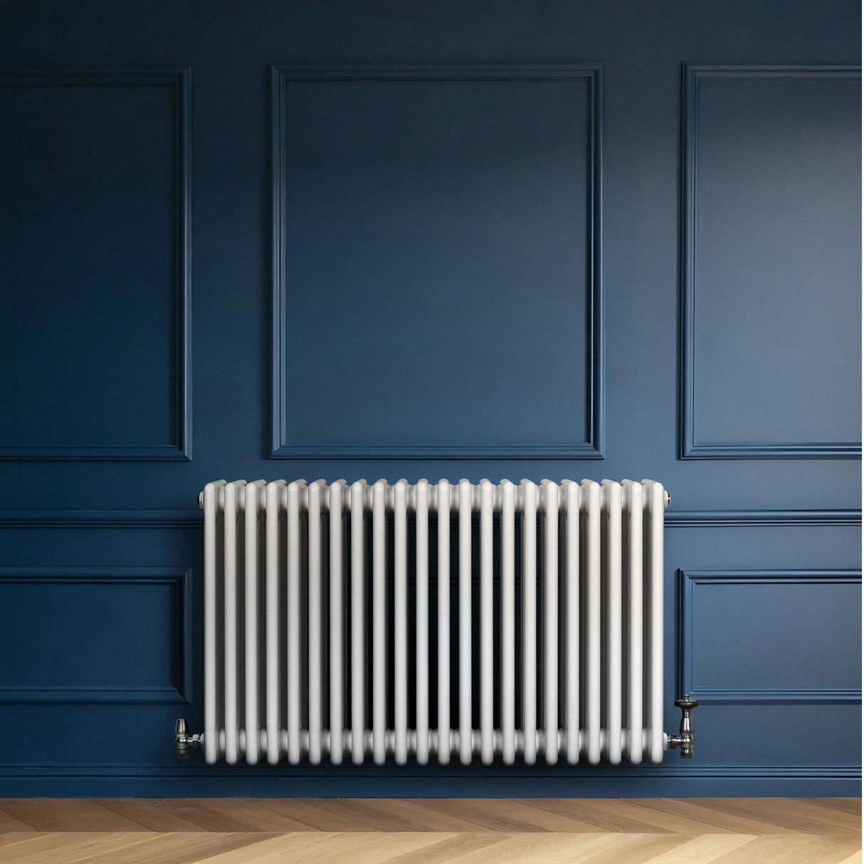 Traditional white 4 column radiator mounted on a blue wall, featuring a sleek design and smooth, glossy finish
