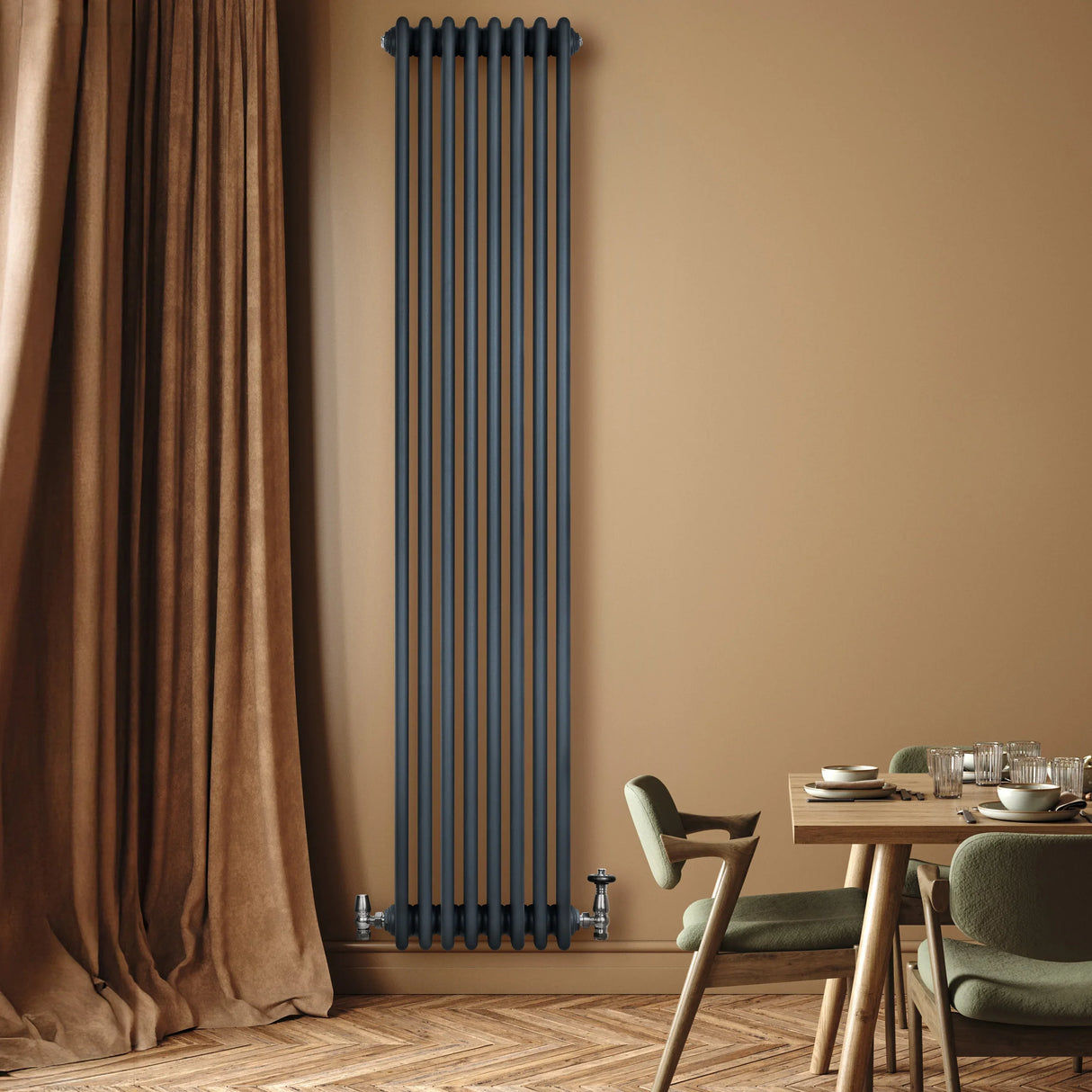 Traditional 4 column radiator in anthracite grey, featuring a sleek vertical design against a warm beige wall and wooden floor