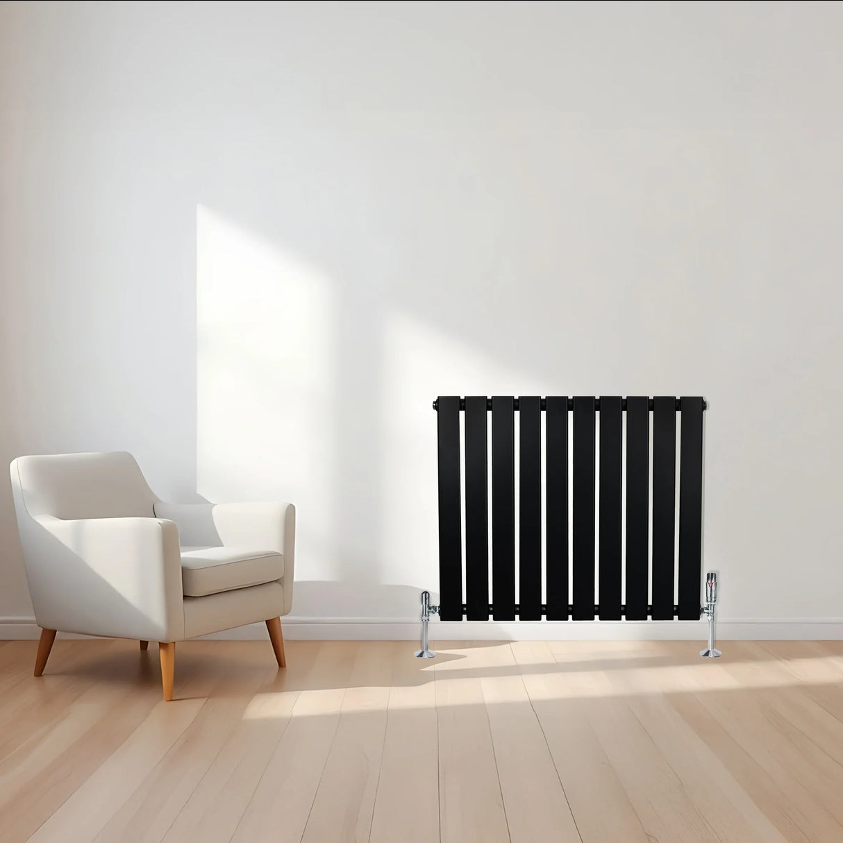 Flat single column radiator in sleek black finish, 600 x 700mm, positioned against a light wall with a modern armchair nearby