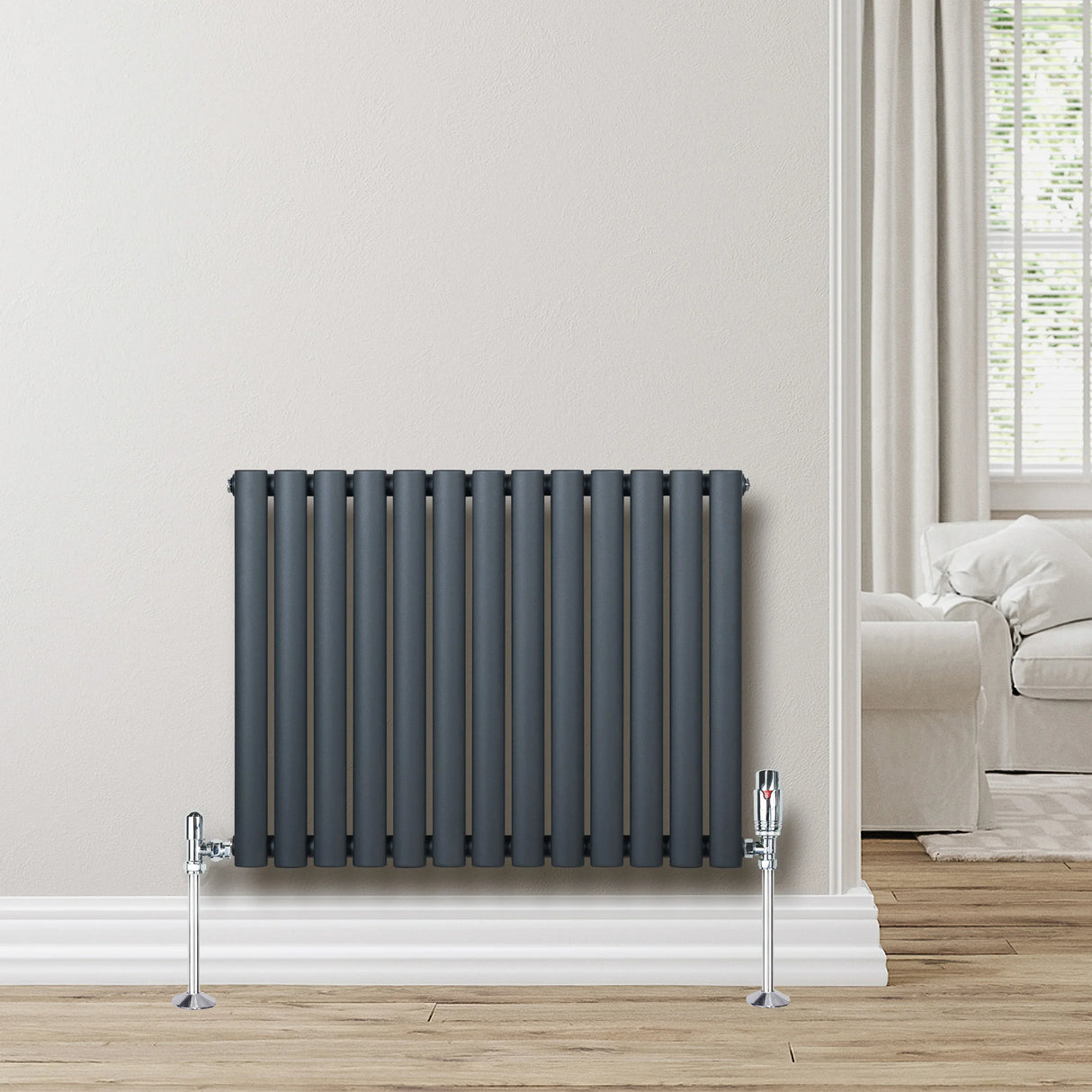 Anthracite grey oval single column radiator, 600 x 780mm, featuring vertical bars and chrome valves, mounted on a light wall