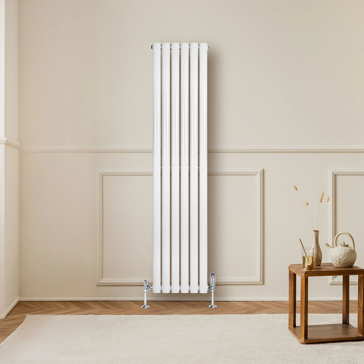 Sleek white oval single column radiator, 1600 x 360mm, mounted on a wall in a modern room with wooden flooring and decor