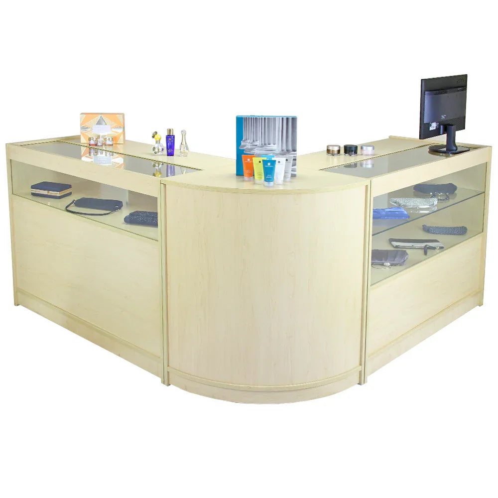 Curved maple reception desk with glass display shelves, modern design, featuring decorative items and a monitor on top