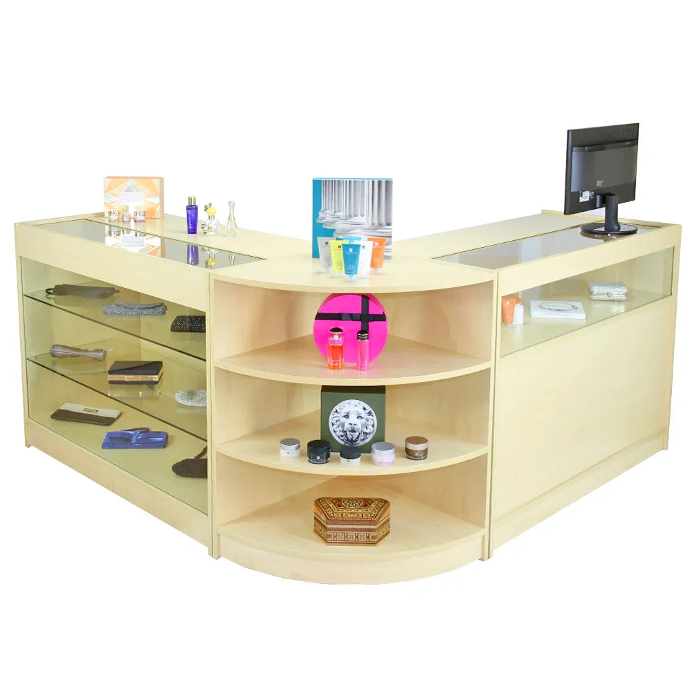 Curved maple retail display counter with glass shelves, showcasing various products and a monitor for customer service