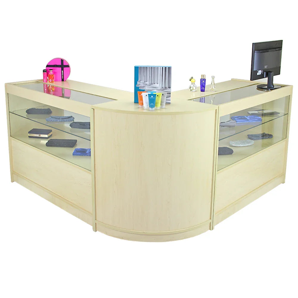 Curved maple reception desk with glass display shelves, showcasing colorful items and a monitor, ideal for modern office spaces