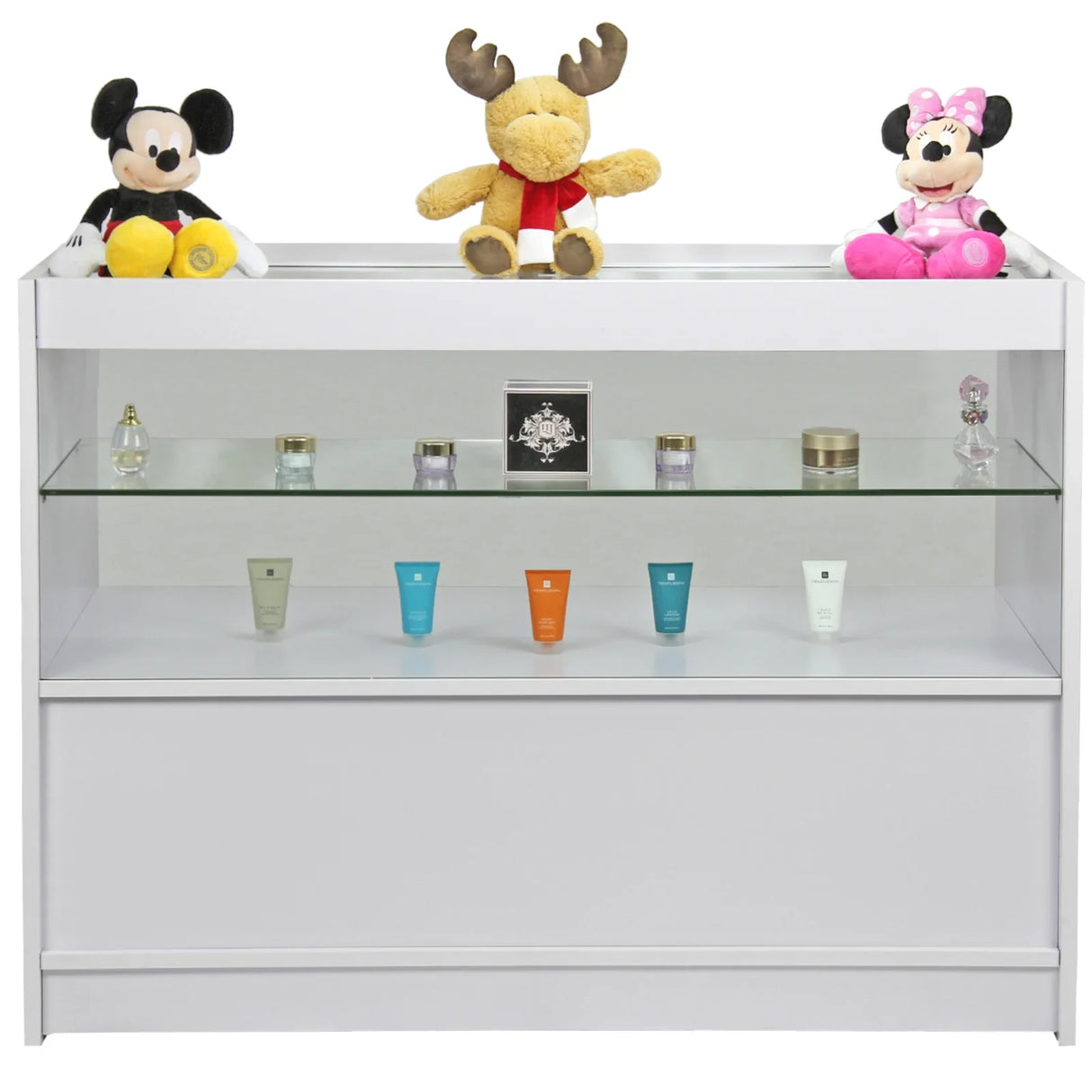 Brilliant white display counter featuring glass shelves, showcasing colorful skincare products and plush toys on top