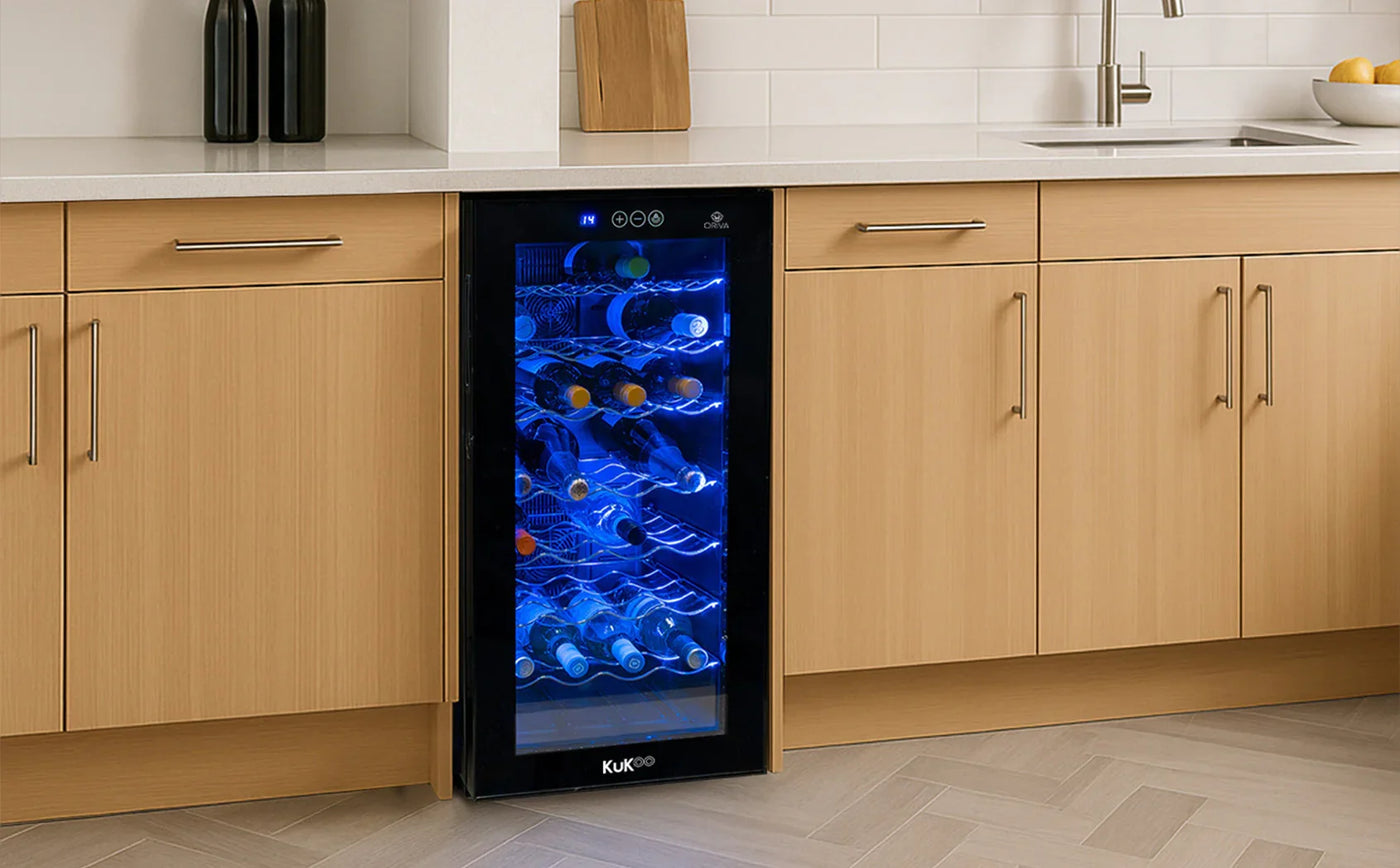 Sleek black wine cooler with blue LED lighting, showcasing a variety of wine bottles on metal racks, set in a modern kitchen cabinetry