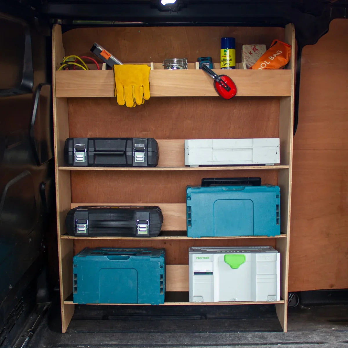 Ford Transit Custom divider racking with multiple shelves, featuring blue and black toolboxes, tools, and a yellow glove on top
