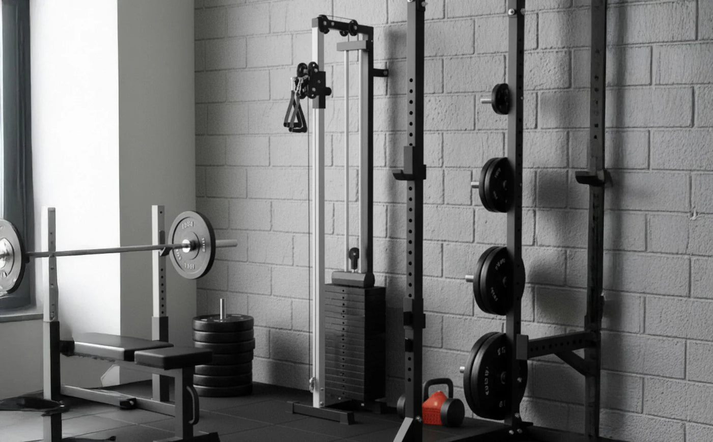 A modern gym setup featuring a weight bench, barbell, cable machine, and free weights against a textured gray wall