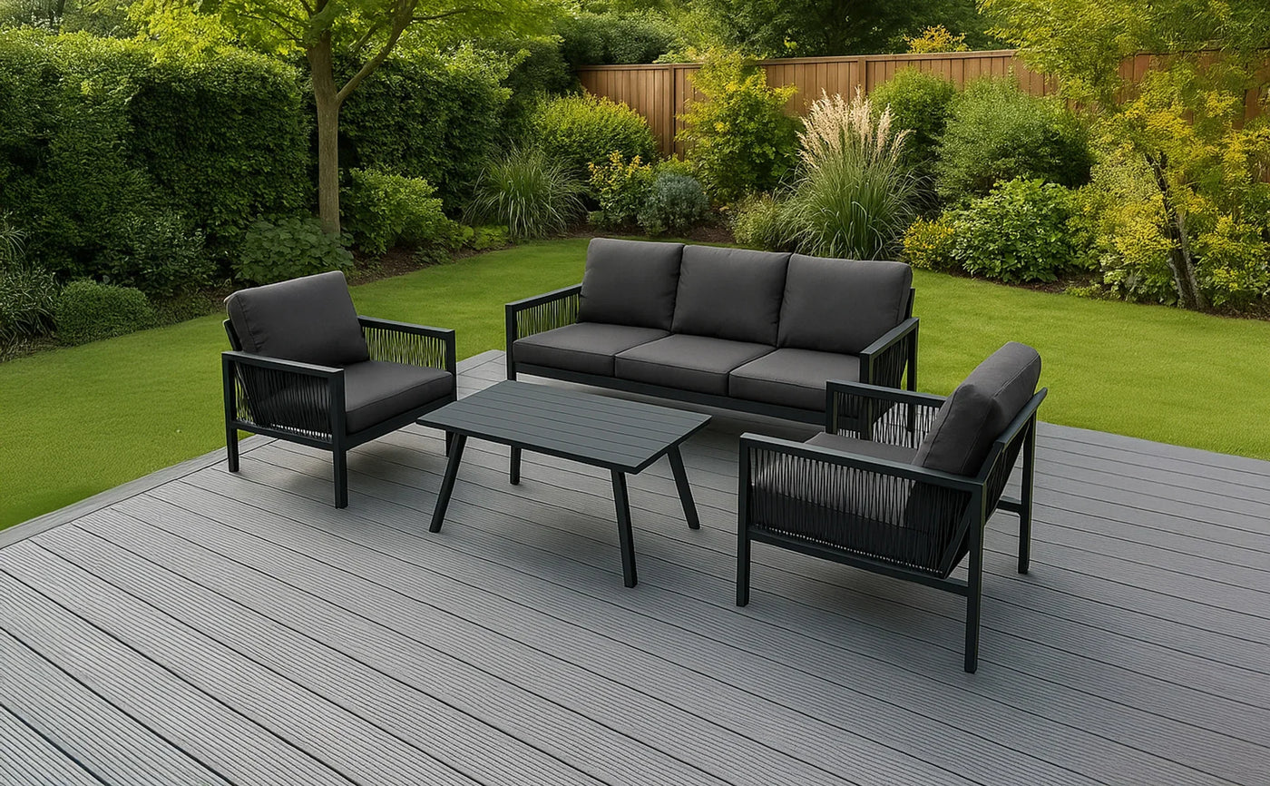 Stylish outdoor seating set featuring a black cushioned sofa and two armchairs, complemented by a matching coffee table on a gray deck