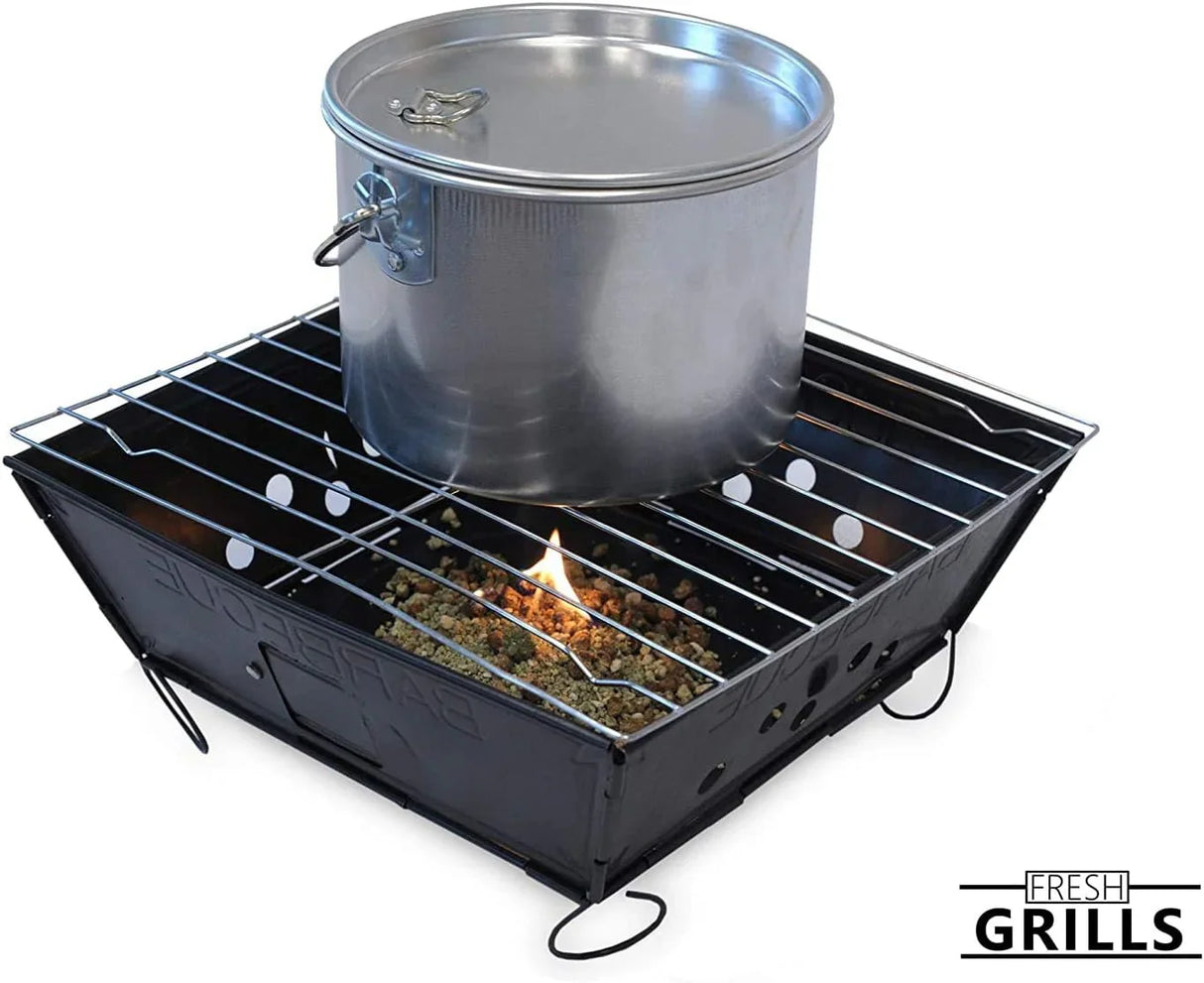 Small portable BBQ grill with a shiny silver pot on top, featuring a sturdy black frame and a flame visible beneath the cooking grate