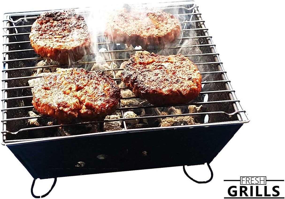 Small portable BBQ grill with four sizzling patties, featuring a sleek black design and stainless steel cooking grate, perfect for outdoor cooking
