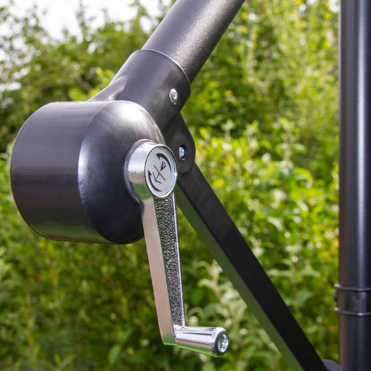 Close-up of the adjustable crank handle on a green 3m LED cantilever parasol, showcasing its sleek design and sturdy construction