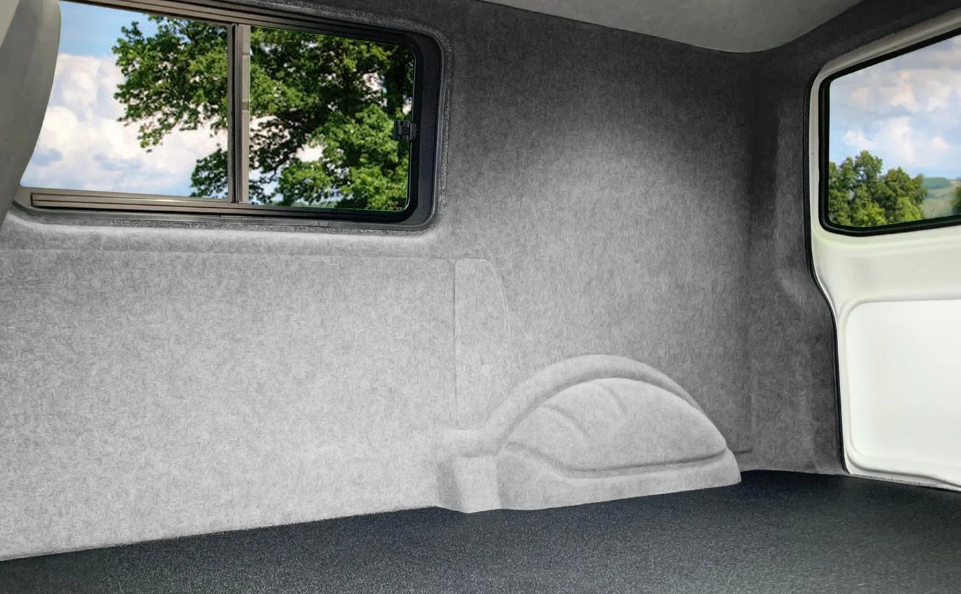 Spacious, gray felt-lined interior of a vehicle with large windows, showcasing a clean, minimalist design and textured surfaces