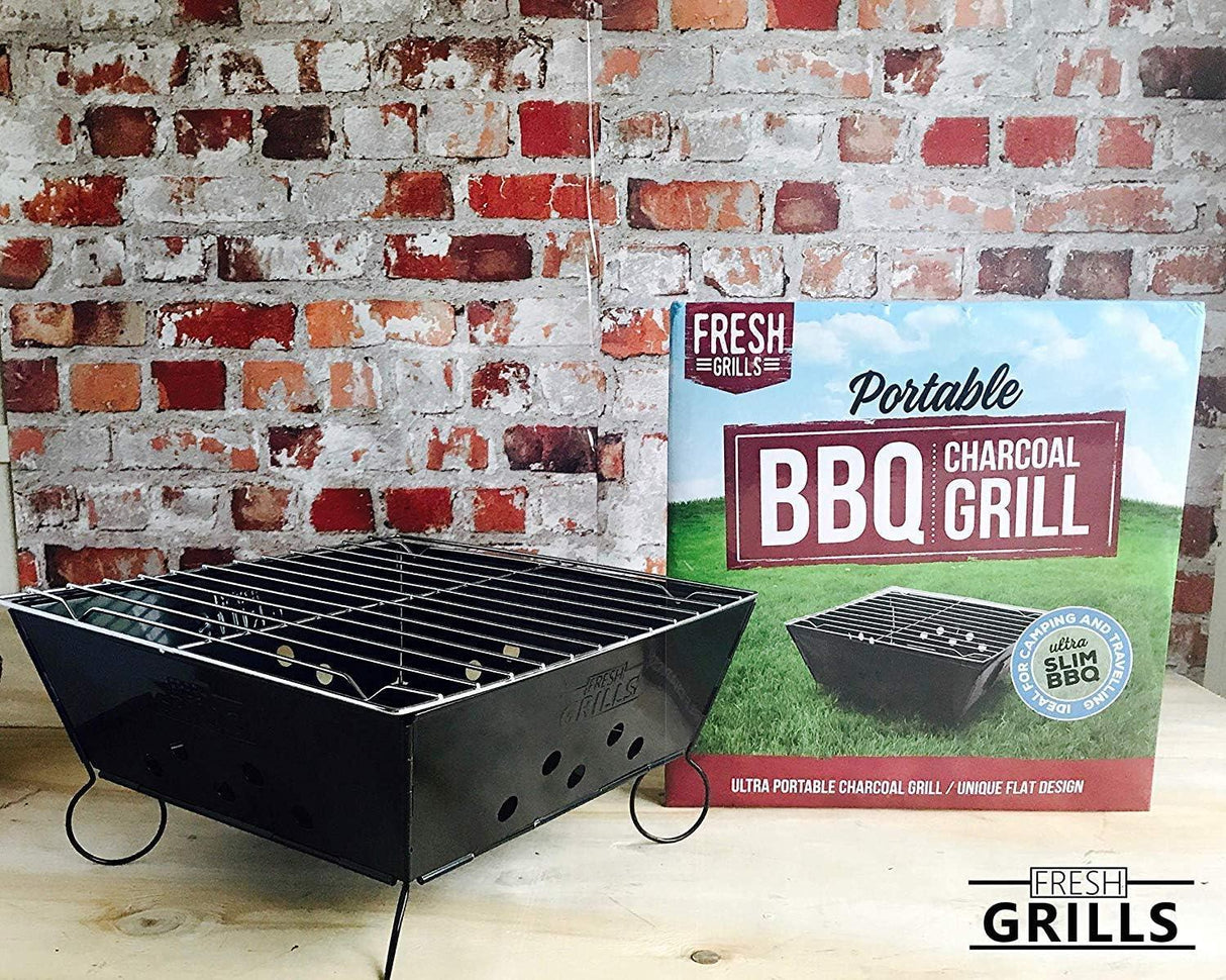 Small portable BBQ grill with a sleek black finish, metal grates, and a compact design, displayed next to its colorful packaging