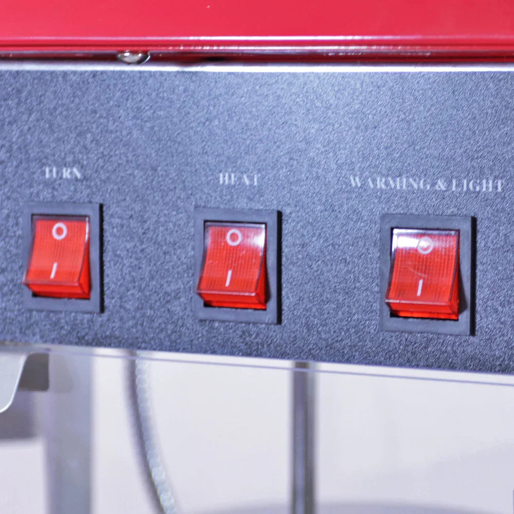 Close-up of the control panel on the KuKoo Commercial 8oz Popcorn Maker, featuring red toggle switches for turn, heat, and warming/light functions