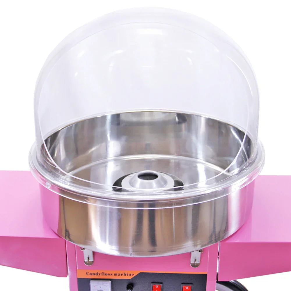 KuKoo candy floss machine features a shiny stainless steel bowl, pink exterior, and a clear protective dome for safe operation