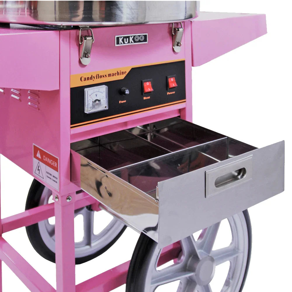 KuKoo candy floss machine in vibrant pink with a stainless steel drawer, control panel, and large wheels for easy mobility