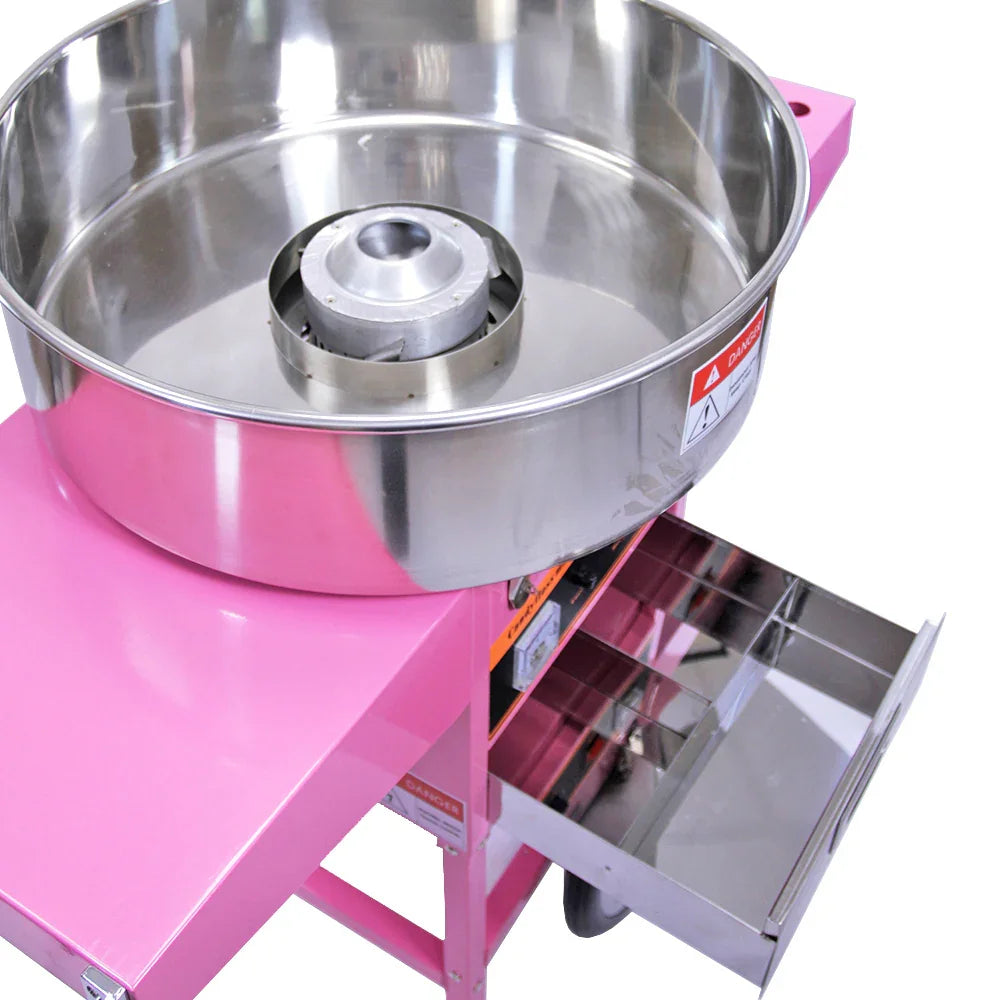 Stainless steel bowl of the KuKoo candy floss machine on a pink cart, featuring a protective dome and a storage drawer underneath