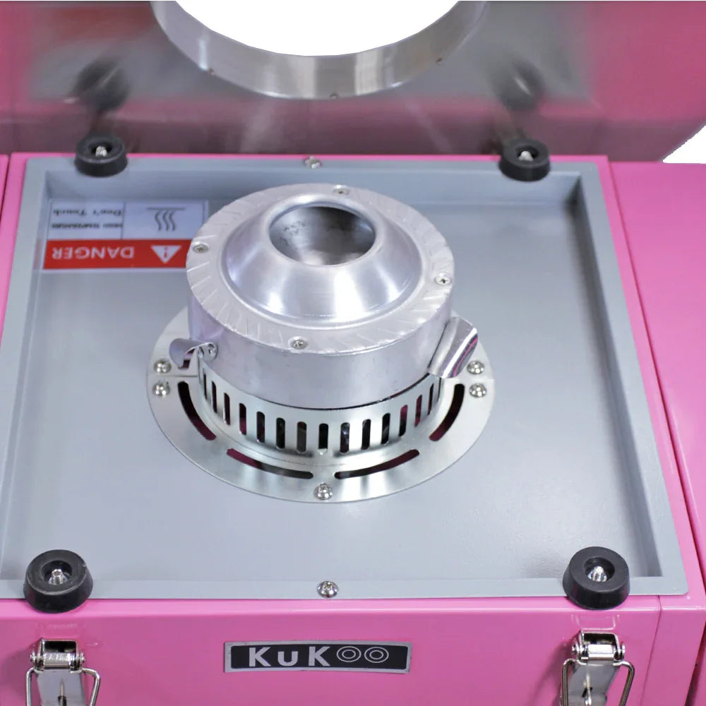 KuKoo candy floss machine top view showing silver heating element, pink cart, and protective dome for safe operation
