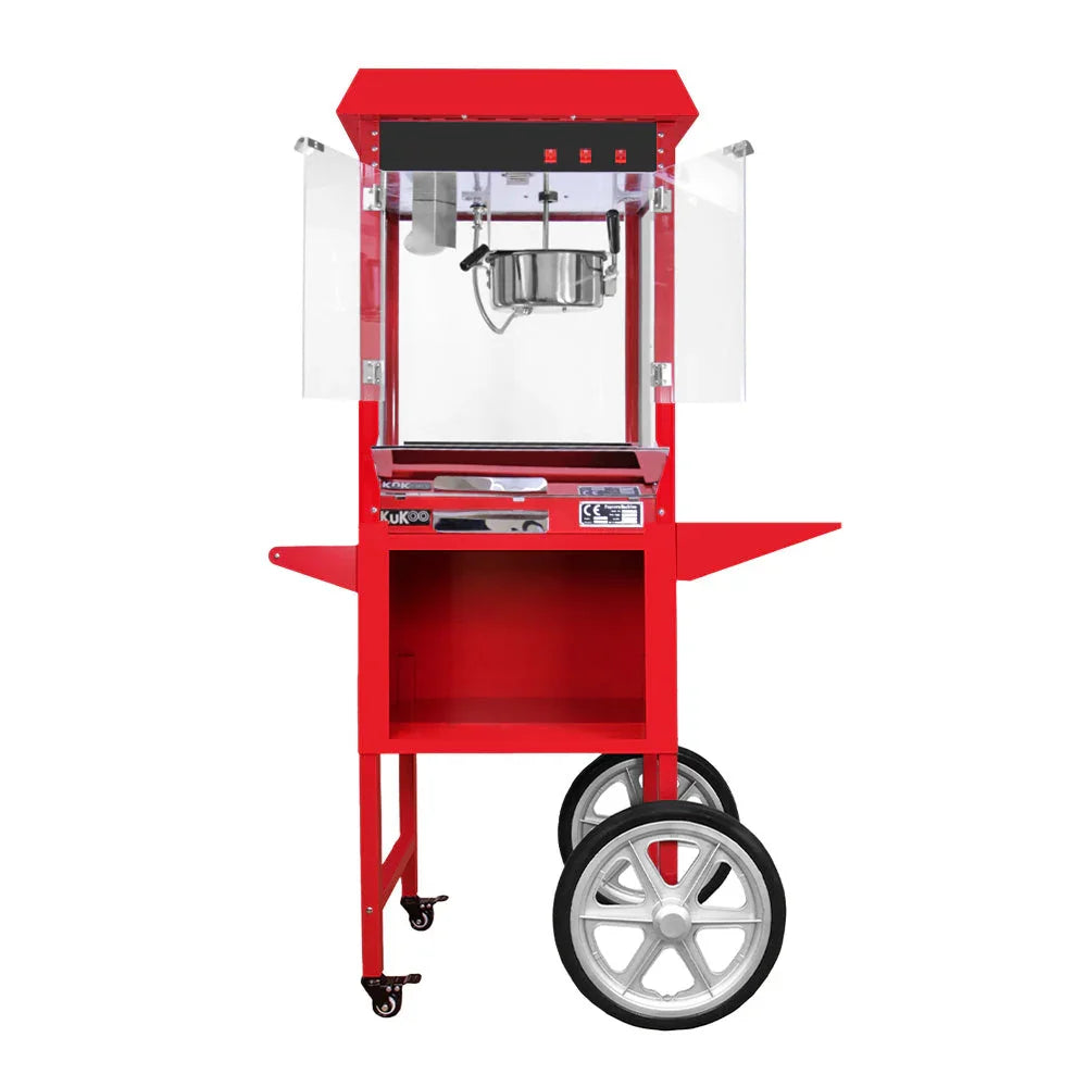 Bright red KuKoo popcorn machine cart with transparent side panels, stainless steel kettle, and sturdy wheels for easy mobility