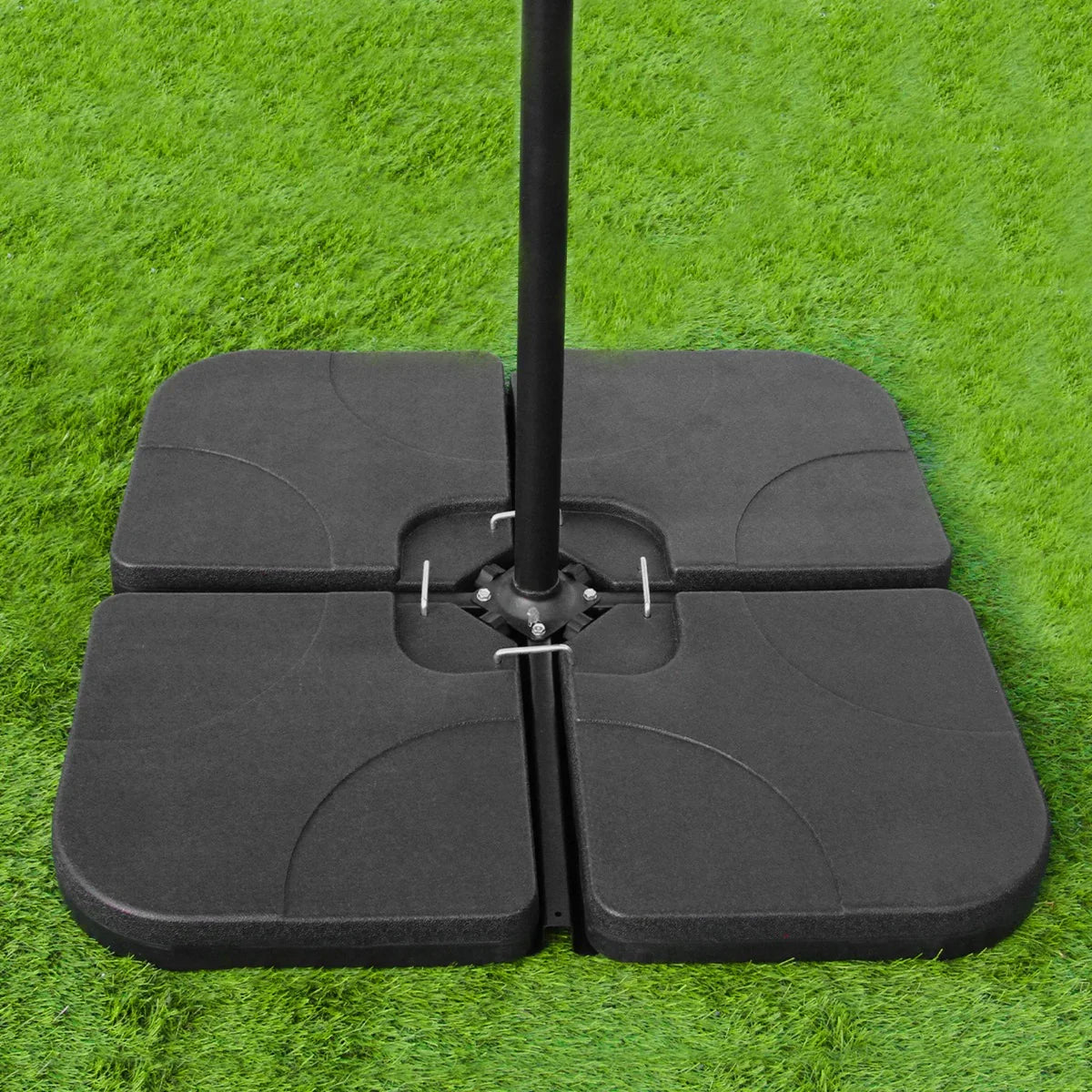 Black plain base for a green 3m LED cantilever parasol, featuring a sturdy design with a textured surface, set on lush green grass