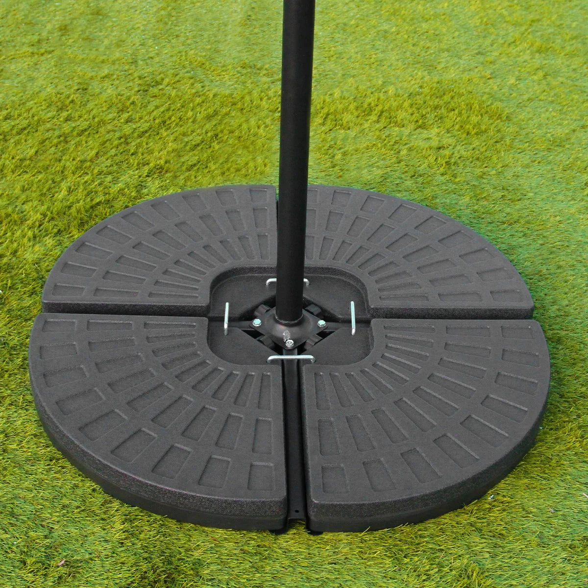 Grey 3m LED cantilever parasol fan base with a textured, circular design, providing stability for outdoor use on grass