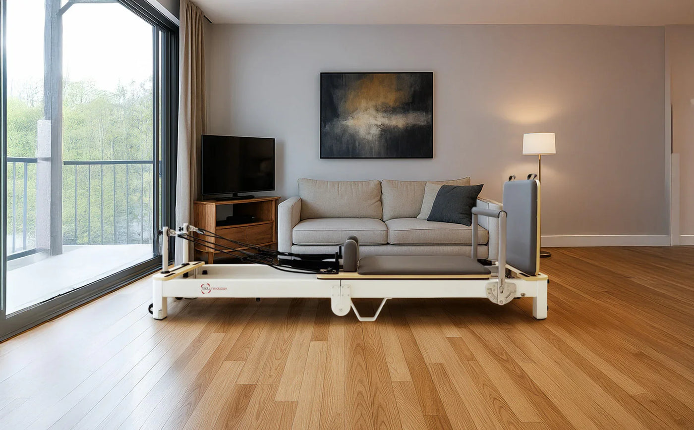 Adjustable hospital bed with a sleek design, positioned on polished wooden flooring in a modern living room with a cozy sofa and large window