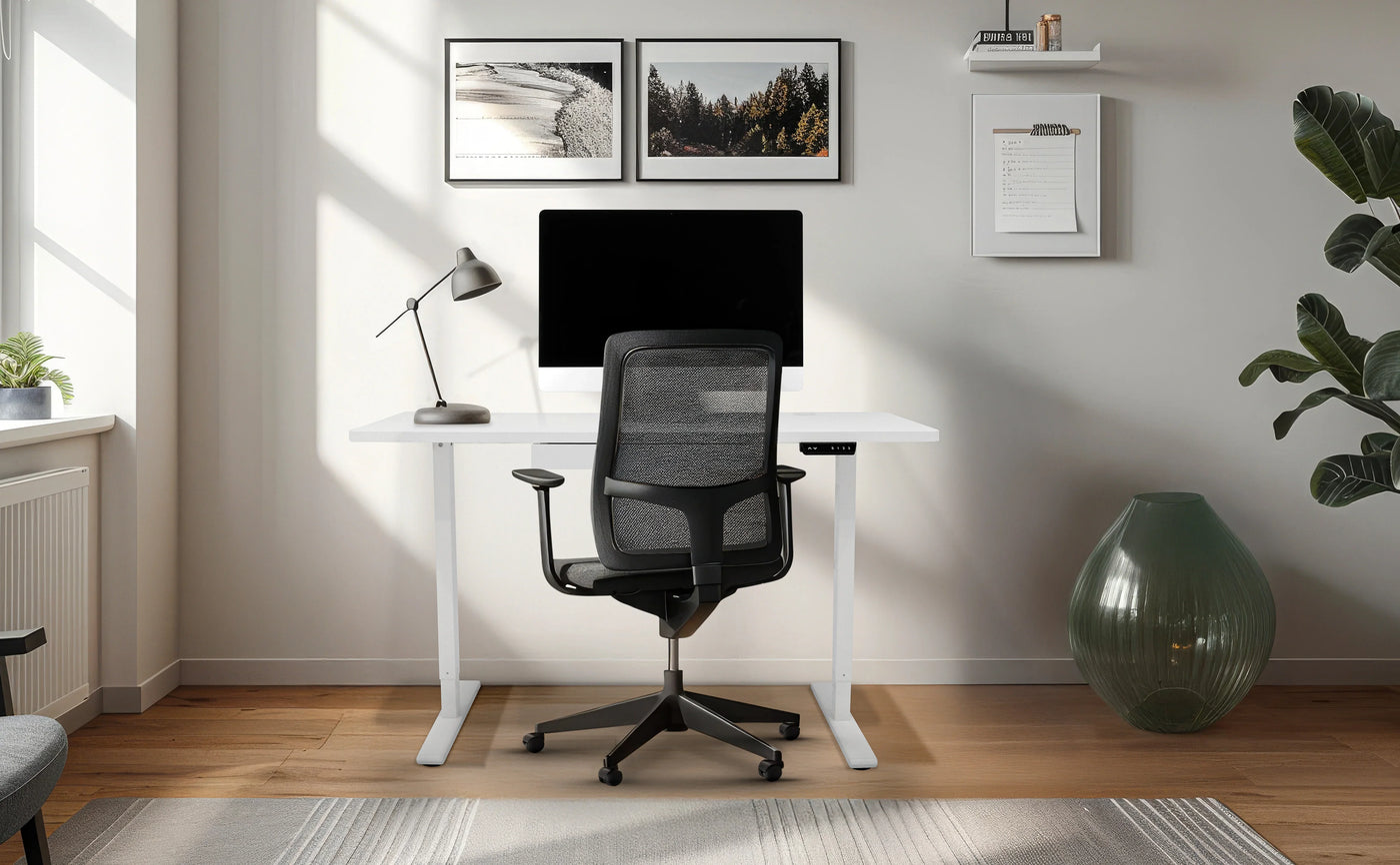 Modern home office setup featuring a sleek white desk, ergonomic black chair, computer monitor, and stylish decor in a bright room