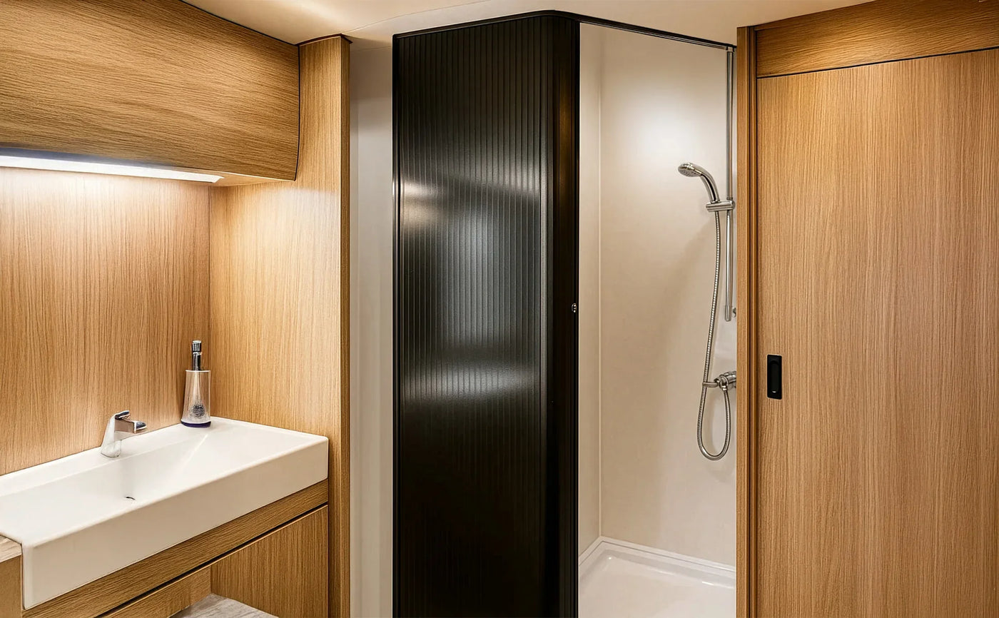 Modern bathroom featuring a sleek black shower enclosure, wooden cabinetry, and a minimalist white sink with a chrome faucet