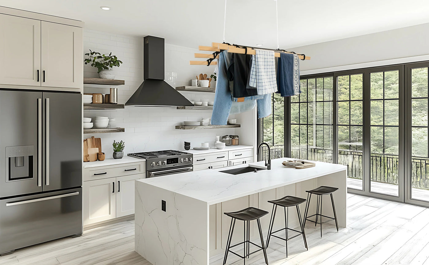 Modern kitchen featuring a large island with white marble, sleek black appliances, and a stylish hanging clothes rack above
