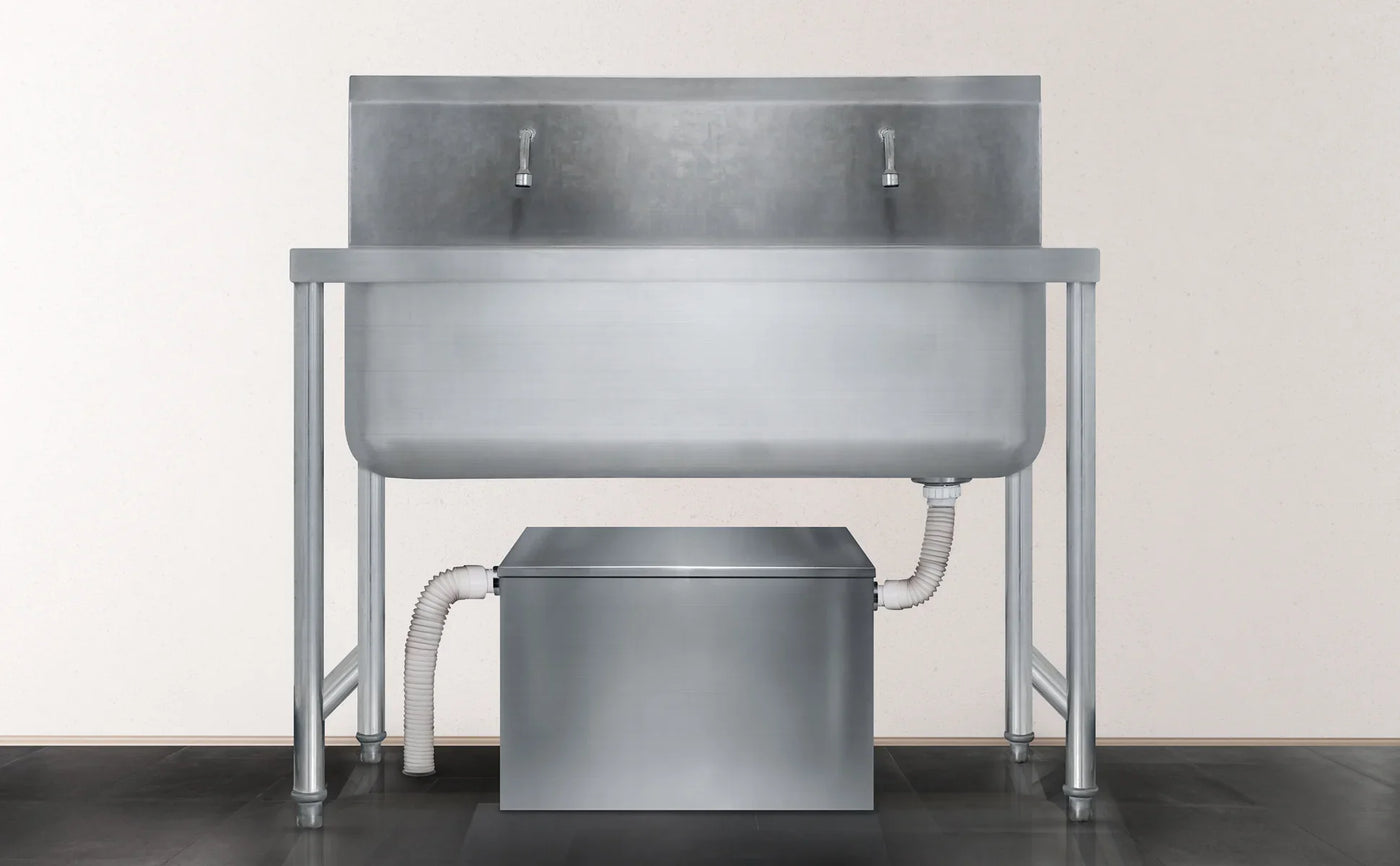 Stainless steel commercial sink with two faucets, mounted on a sturdy frame, featuring a sleek, modern design and smooth finish
