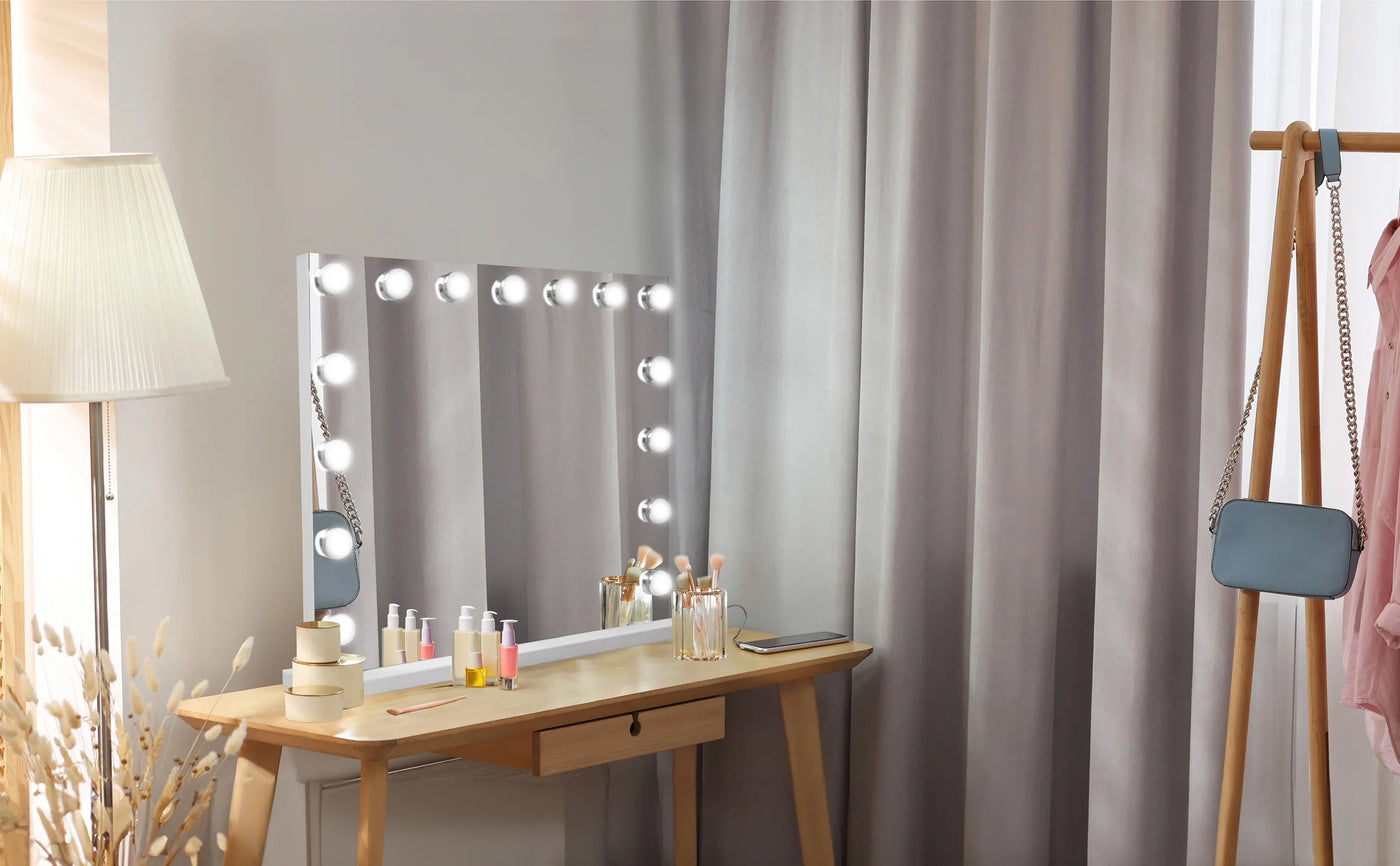 Vanity table with a bright mirror, soft gray curtains, and beauty products arranged neatly, creating a stylish makeup space