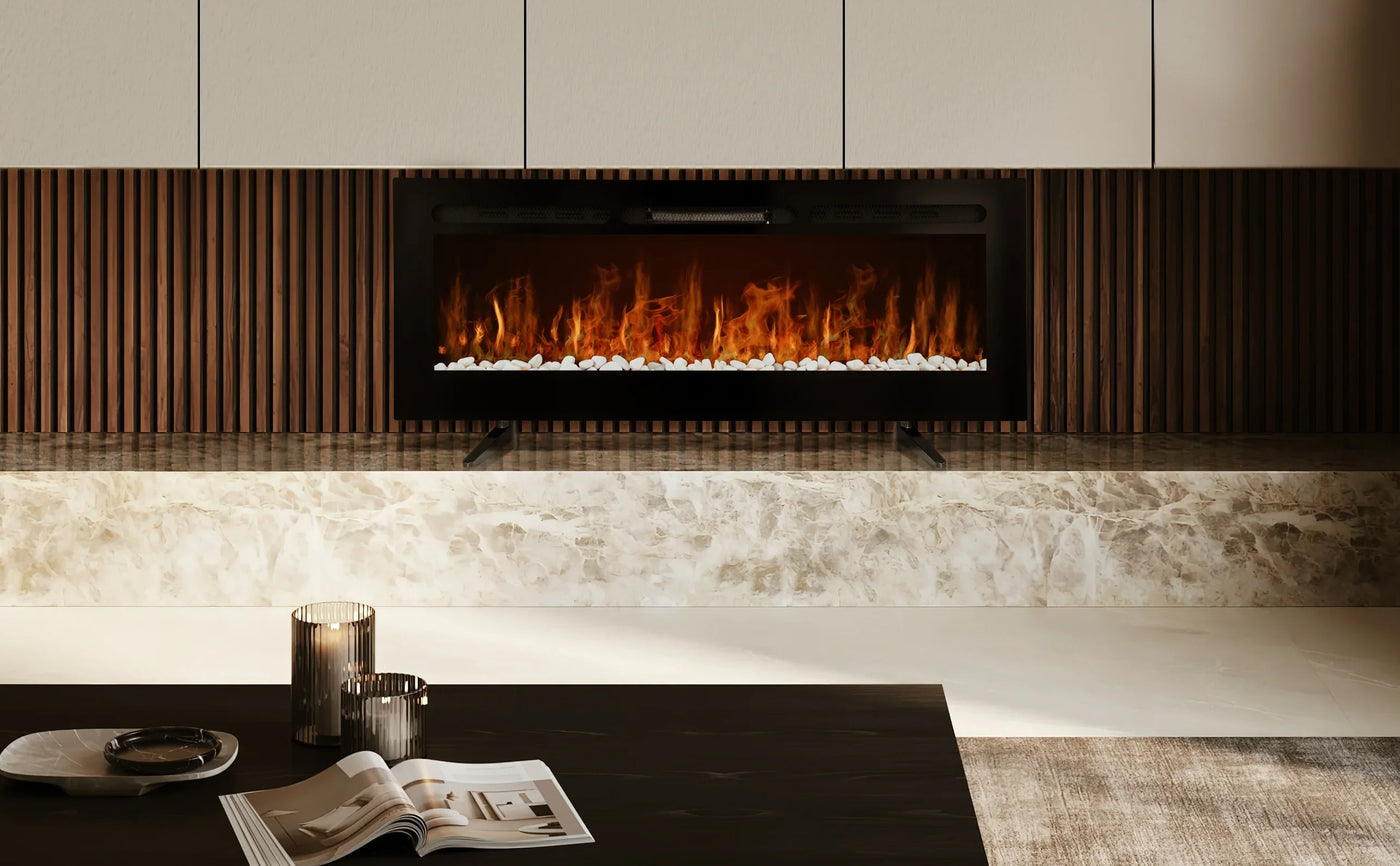 Modern electric fireplace with realistic flames, black frame, white pebbles, set against a sleek marble base and wooden paneling