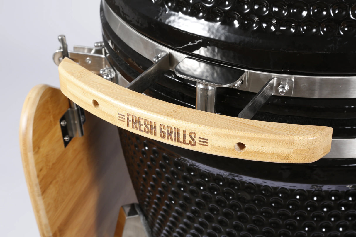 Fresh Grills Kamado Charcoal BBQ Grill 21" with a sleek black finish, bamboo handle, and textured ceramic body for optimal grilling