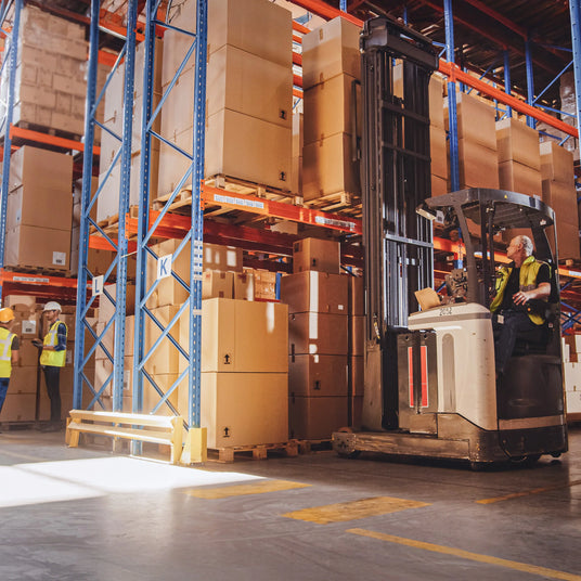 Warehouse scene with a forklift operator moving large cardboard boxes on shelves, bright lighting highlighting the organized space