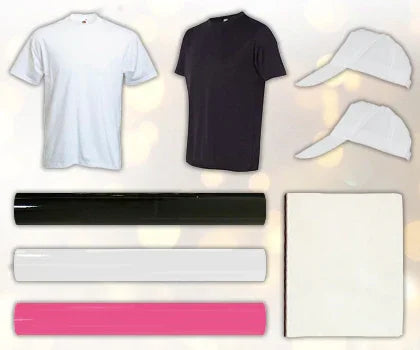 PixMax PRESStige Bundle featuring white and black t-shirts, pink and black vinyl rolls, and two white caps on a soft background