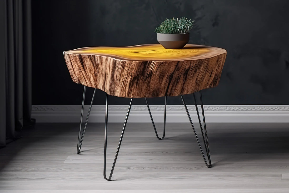 Rustic wooden table with a live edge and vibrant yellow resin inlay, supported by sleek black hairpin legs, styled with a small plant