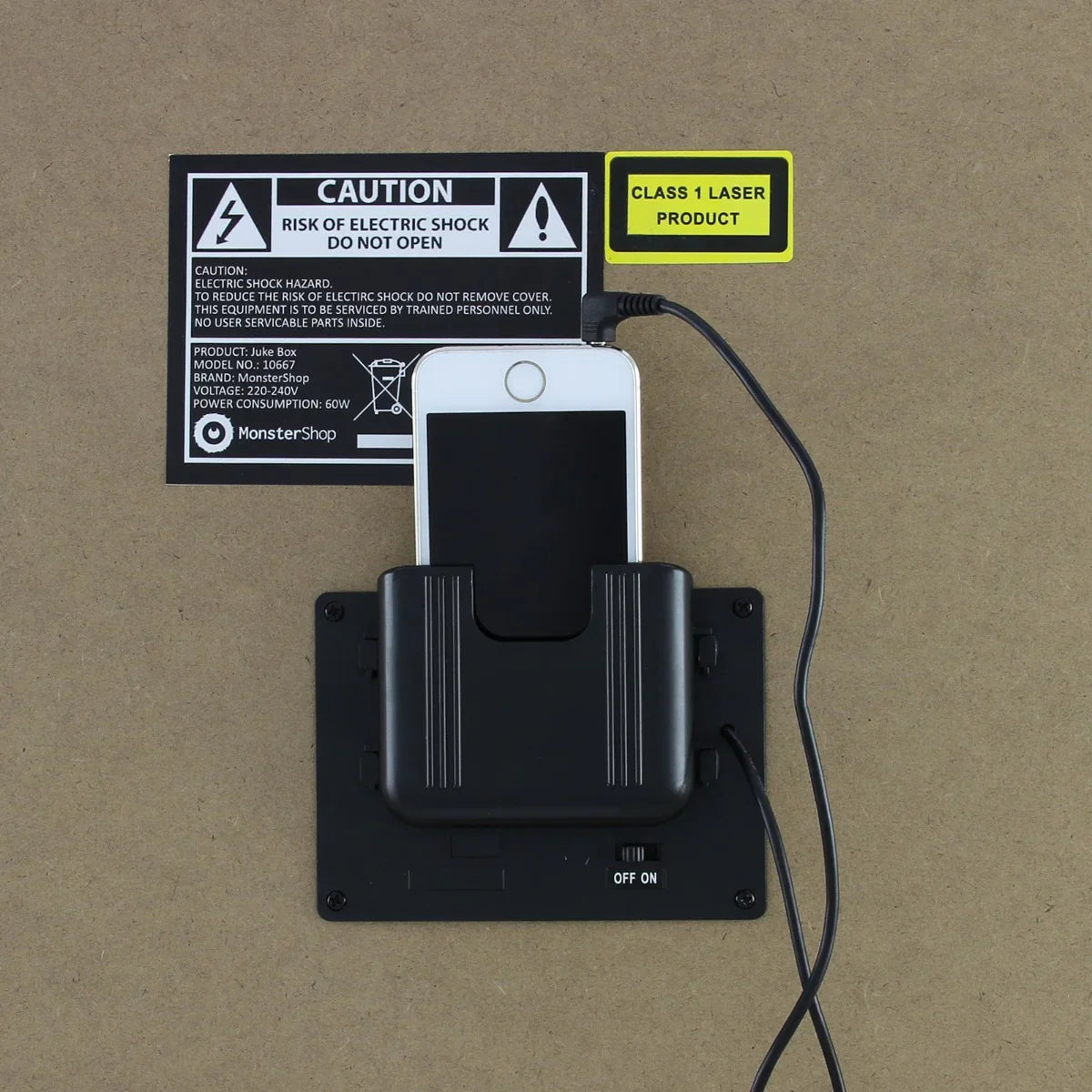 Retro jukebox sound system with a sleek black phone dock, illuminated design, and caution labels for safety information