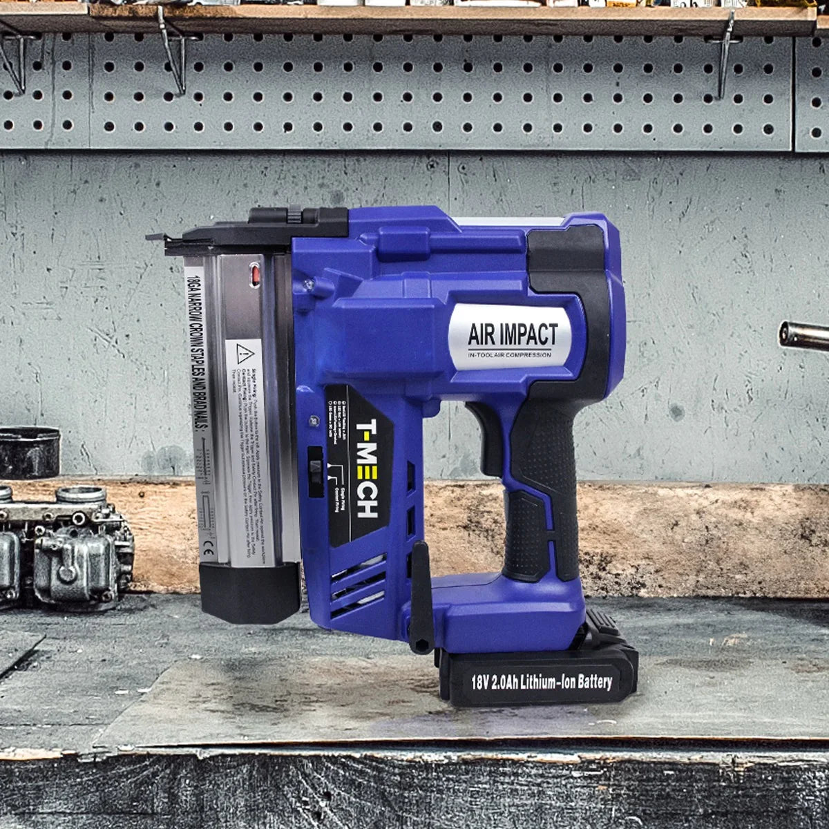 T-Mech Nail & Staple Gun in blue with a lithium-ion battery, featuring a sturdy grip and a sleek design on a workbench backdrop