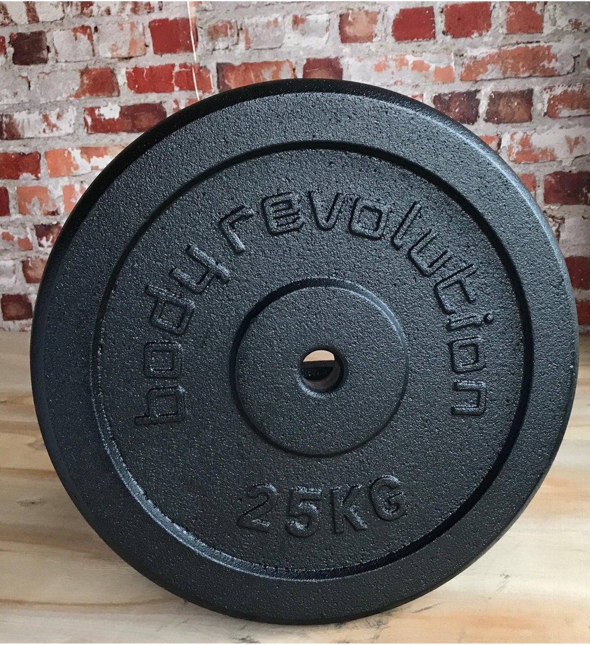 25kg cast iron weight plate with textured surface and embossed lettering, ideal for strength training and home gyms