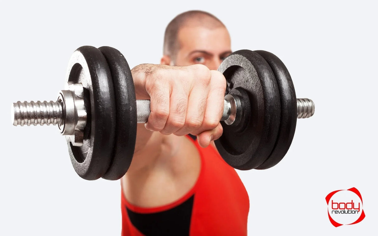 Cast iron weight plates attached to a dumbbell, held by a muscular hand, showcasing a matte black finish and textured grip