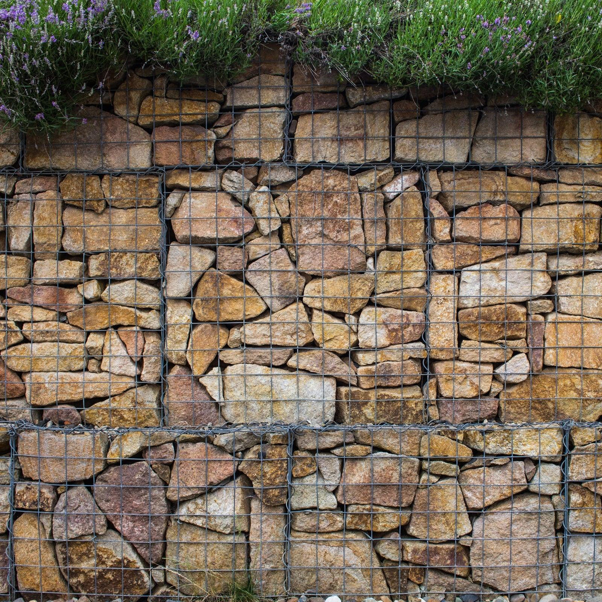 Gabion baskets filled with natural stones, showcasing a sturdy wire mesh structure, ideal for landscaping and erosion control