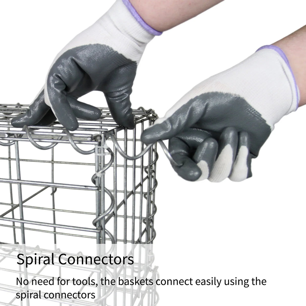 Hands wearing gray and white gloves connect gabion baskets using spiral connectors, showcasing their easy assembly and sturdy design