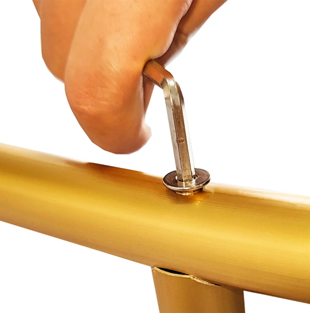 Hand tightening a silver bolt on the gold Wedding Moongate, showcasing its sleek metal finish and sturdy construction
