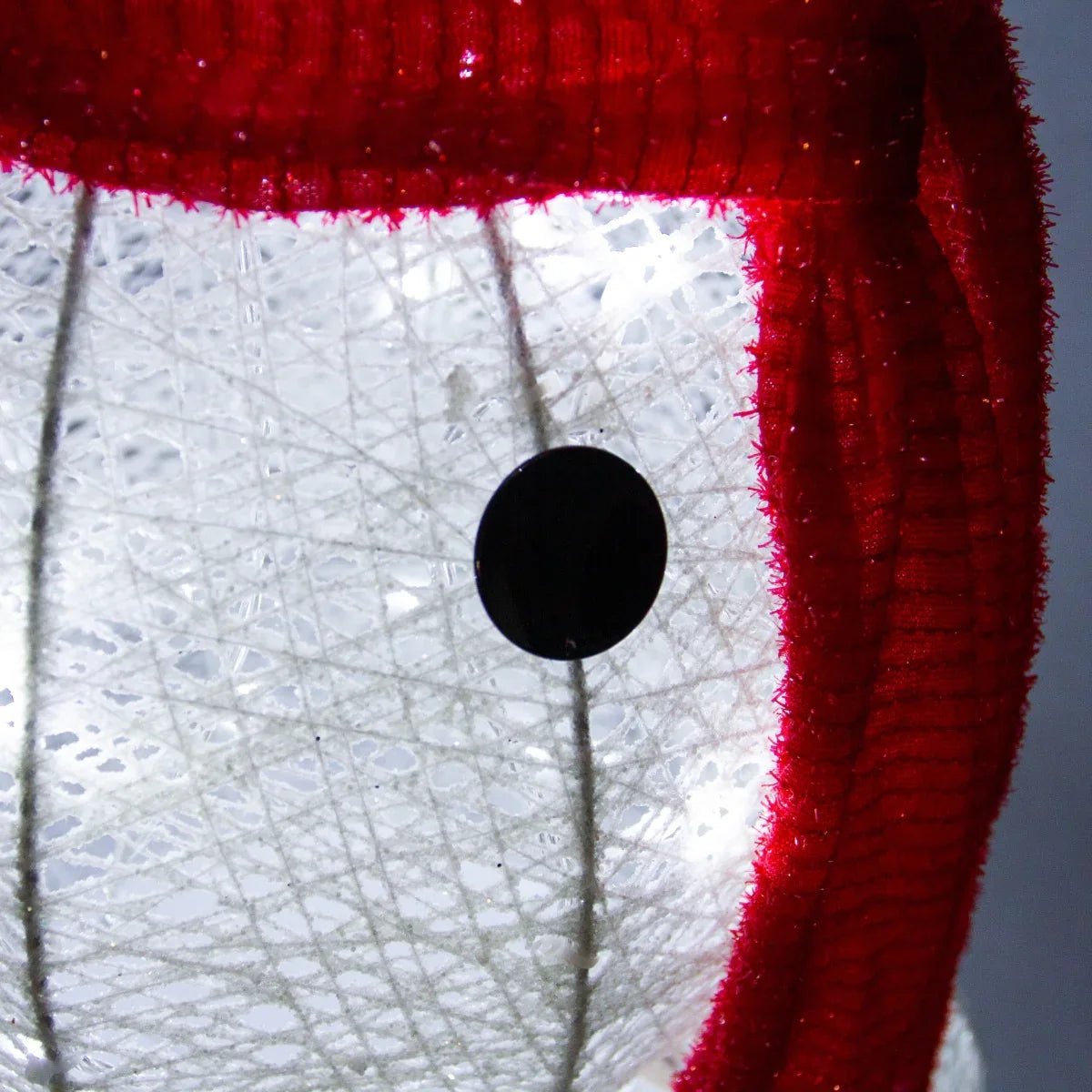 Light-Up Snowman features a textured white body, bright lights, and a red scarf, creating a festive holiday decoration