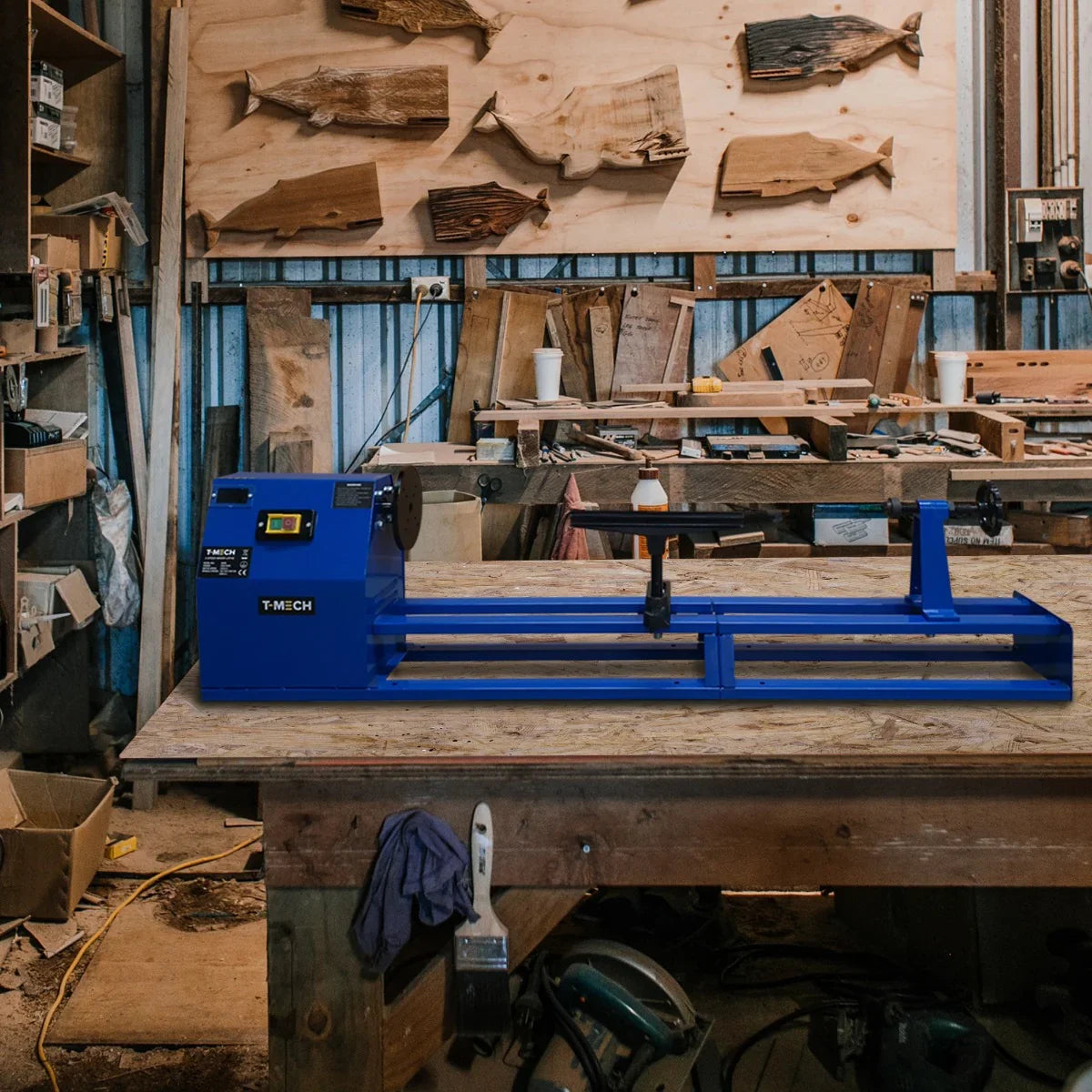 T-Mech Wood Lathe in vibrant blue, featuring a sturdy design on a wooden workbench surrounded by woodworking tools and materials