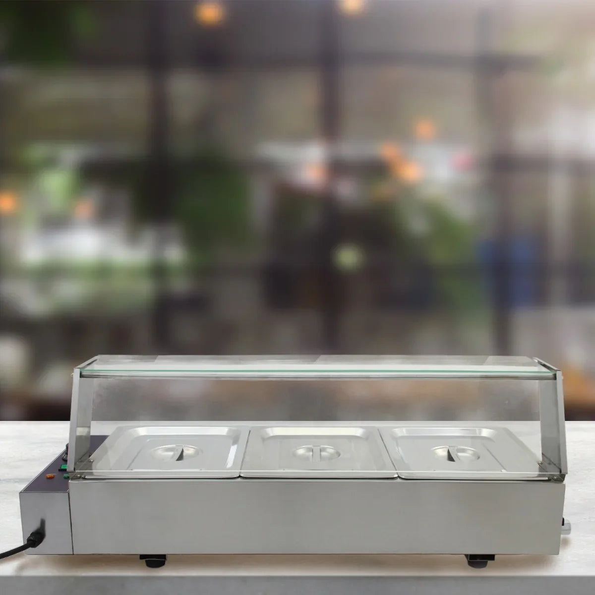 Stainless steel KuKoo 3 Pan Wet Well Bain Marie with clear glass lid, ideal for keeping food warm in a buffet setting